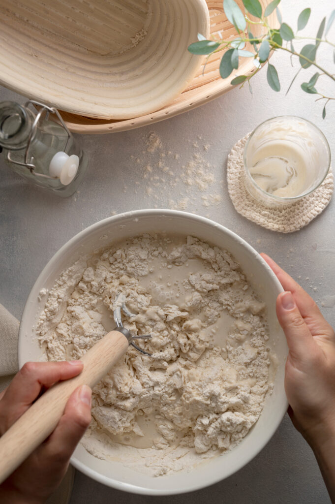 sourdough mixed in a bowl with a danish whisk
